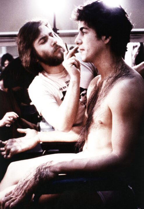 AN AMERICAN WEREWOLF IN LONDON, from left: makeup artist Rick Baker working on David Naughton on set, 1981,
