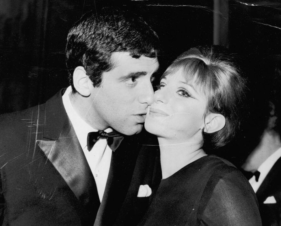 American actress and singer Barbra Streisand receives a kiss from her husband, actor Elliott Gould, on her opening night in 'Funny Girl' at the Prince of Wales Theatre, London, 13th April 1966