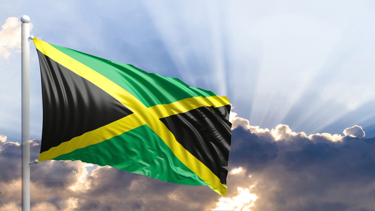 Jamaica waving flag on blue sky. 3d illustration