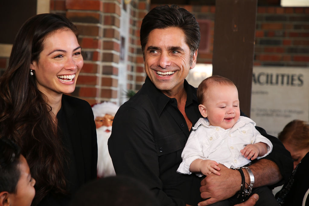 BEAUMONT, CA - NOVEMBER 27: John Stamos (C), his wife Caitlin McHugh (L) and their son, Billy Stamos (R) attend a special event in which John Stamos is named as national spokesman for Childhelp National Child Abuse Hotline at Childhelp Merv Griffin Village on November 27, 2018 in Beaumont, California