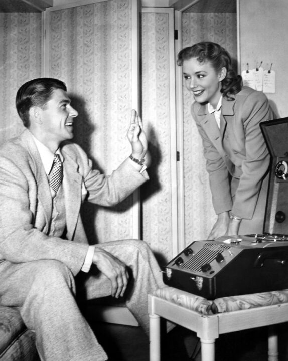 LOUISA, from left: Ronald Reagan, Piper Laurie, listening to playback from their line reading on a wire recorder, 1950