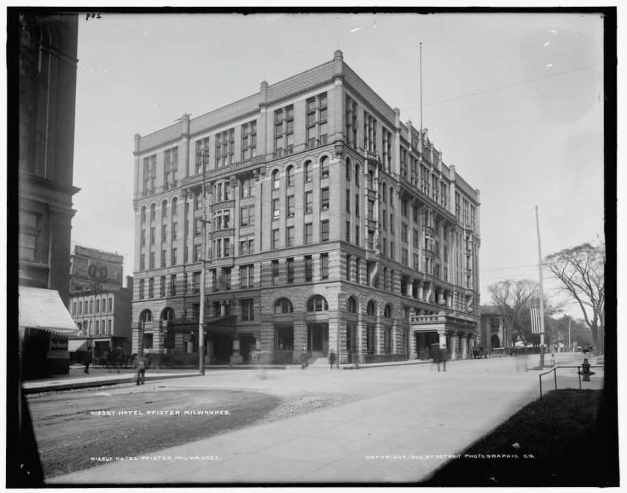 Hotel Pfister, Milwaukee, circa 1900. The Pfister, vision of businessman Guido Pfister and his son Charles, was designed by Charles Koch, and opened in 1893. It boasted groundbreaking innovations such as fireproofing, electricity throughout the hotel and individual thermostat controls in every room. Note Republican State Central Committee Headquarters next door. Creator: Unknown