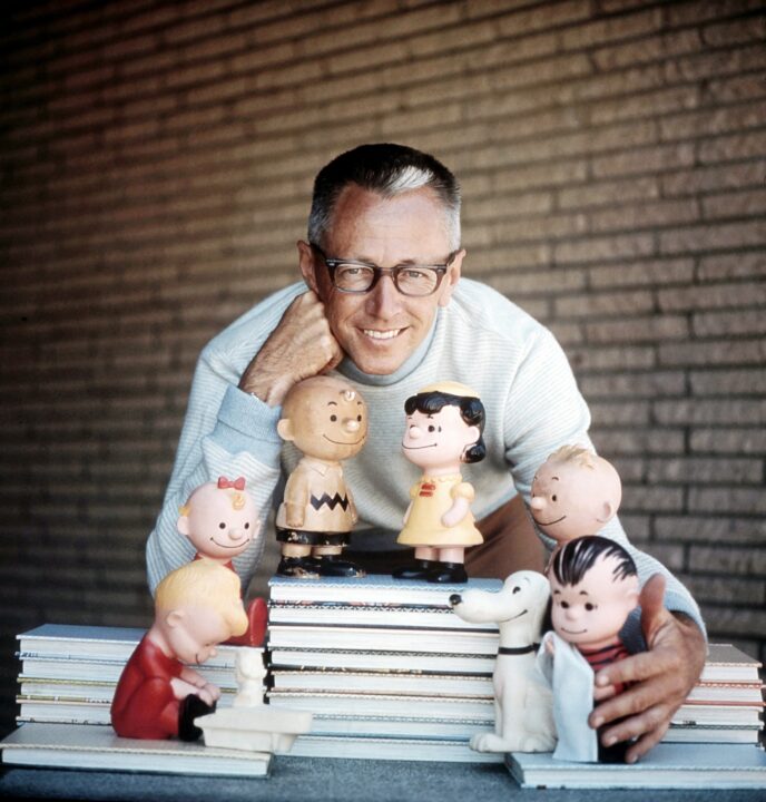 Peanuts cartoonist Charles Schulz (aka Charles M. Schulz) surrounded by his characters (from left, Schroeder, Sally, Charlie Brown, Lucy van Pelt, Snoopy, Shermy, Linus van Pelt), ca. late 1950s