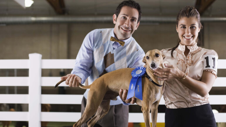 Couple with dog at a dog show