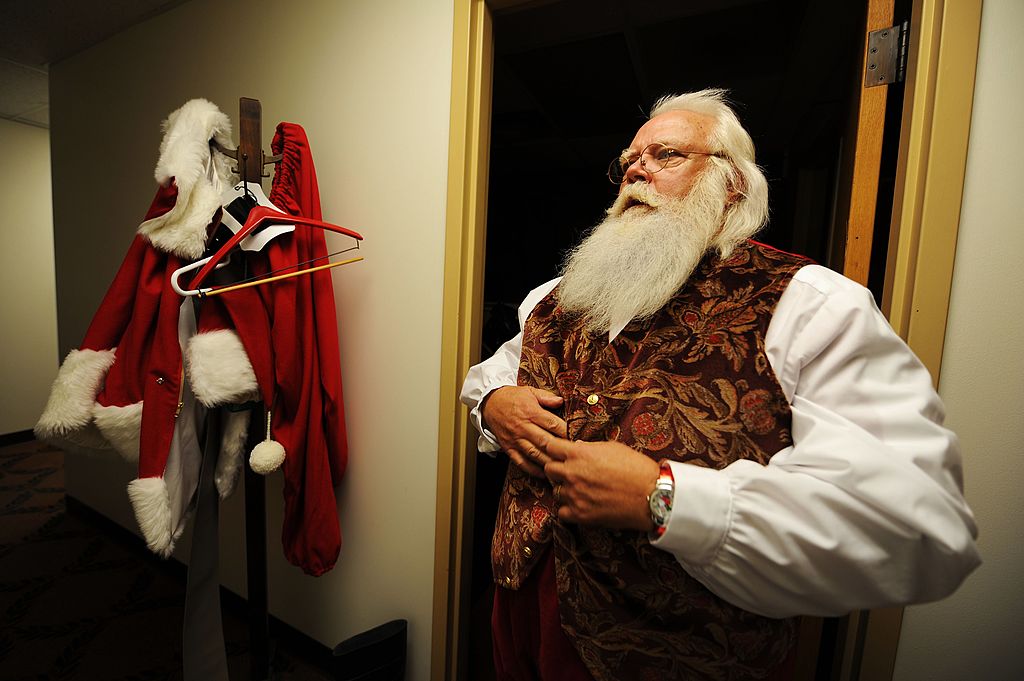 MIDLAND, MI - OCTOBER 17: Santa Claus student Tom Carmendy, of Westminster, Colorado puts on his Santa Claus suit prior to performing for a group of elementary school children during the Charles W. Howard Santa Claus School workshop on October 17, 2008 in Midland, Michigan. The legend of Santa Claus has endured many centuries. The Charles W. Howard Santa Claus School is becoming legendary as it is in it's 71st year of classes. Student Santas gather from around the world to share their common love of Christmas and the magical spirit of Santa Claus. They share their stories, learn common traditions, and values that started at this school from the beginning