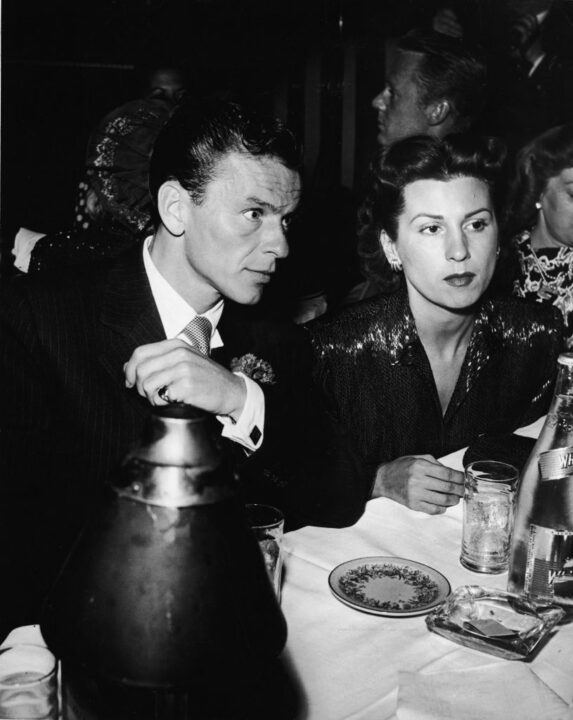 American singer and actor Frank Sinatra (1915 - 1998) and his first wife Nancy Barbatto at a restaurant, c. 1946