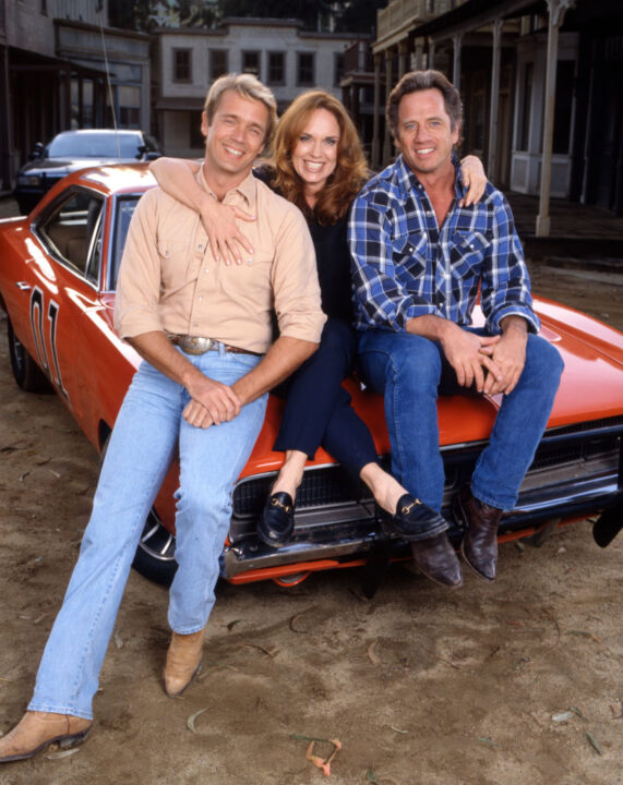 LOS ANGELES - APRIL 25: Pictured from left is John Schneider (as Bo Duke), Catherine Bach (as Daisy Duke), Tom Wopat (as Luke Duke), in the made for television movie, THE DUKES OF HAZZARD: REUNION!. Air date April 25, 1997