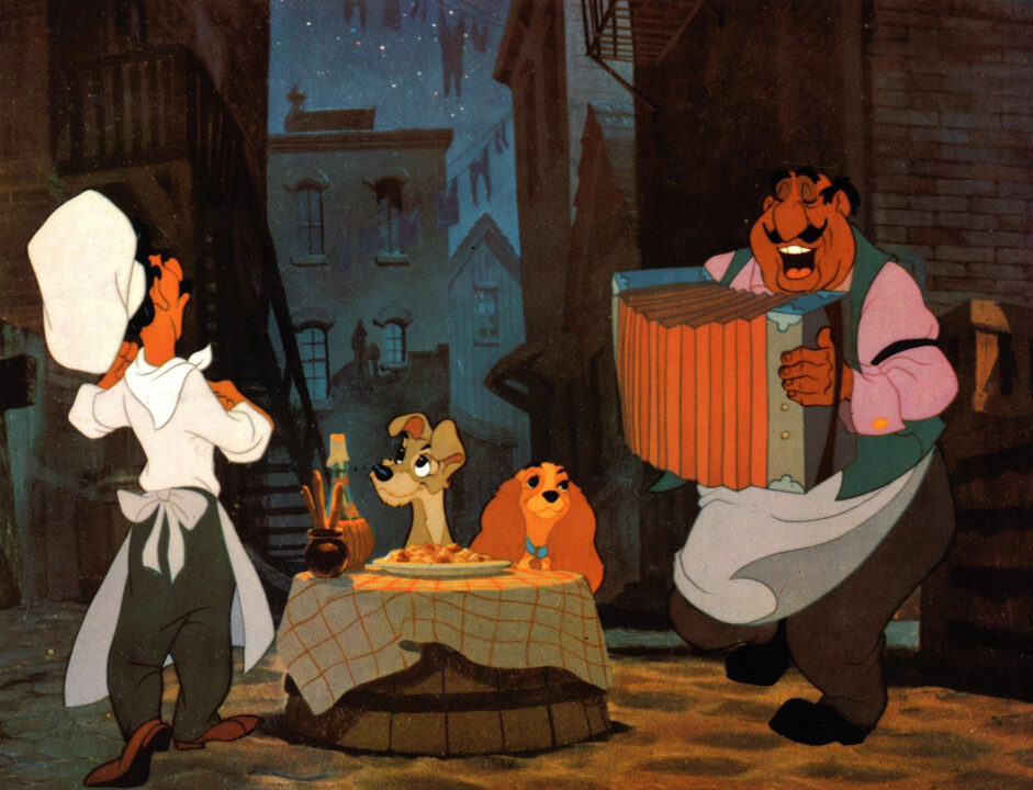 image from the 1955 Walt Disney animated feature "Lady and the Tramp." it is from the famous scene where the title dog characters are having a romantic spaghetti dinner in an alley, serenaded by a singing cook and a man playing an accordian.