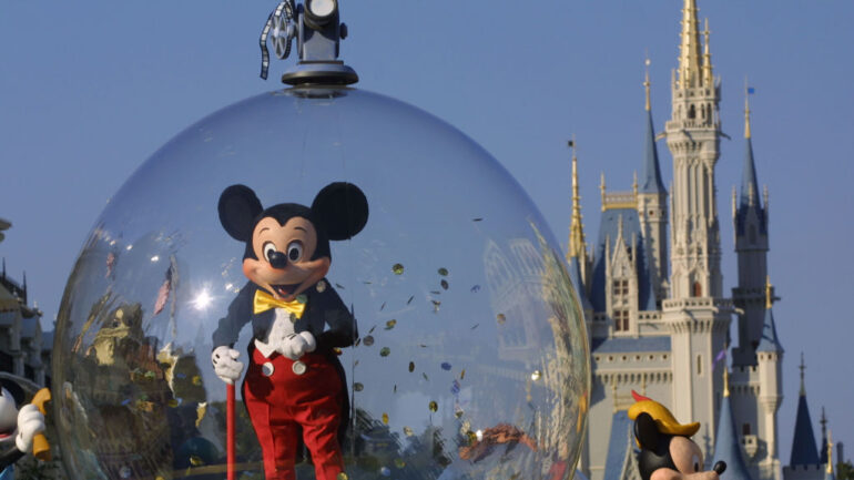 Mickey Mouse rides in a parade through Main Street, USA with Cinderella's castle in the background at Disney World's Magic Kingdom November 11, 2001 in Orlando, Florida