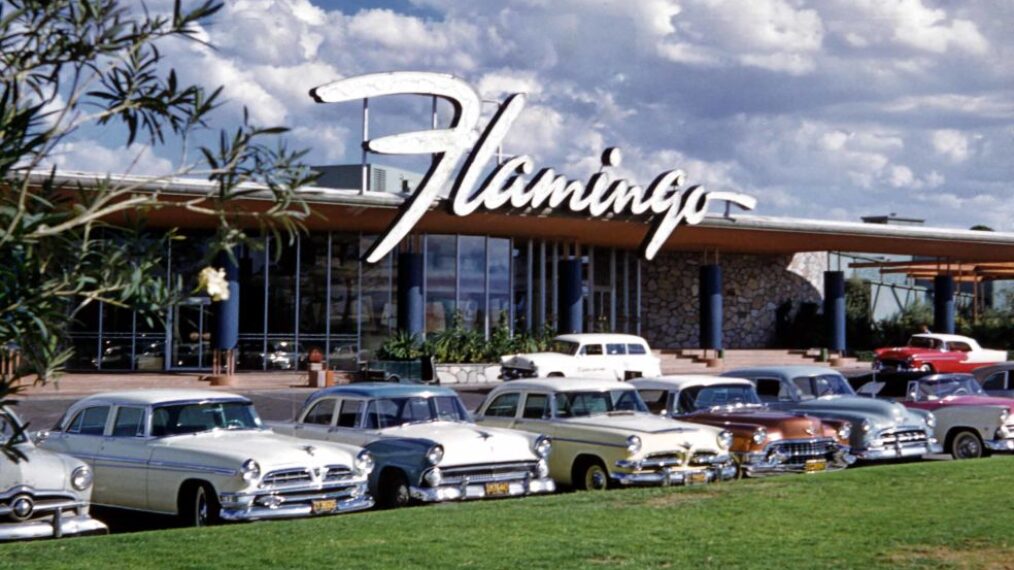 Daytime view of the front entrance to the Flamingo Hotel and Casino, with cars parked in the foreground, Las Vegas, Nevada, early 1950s