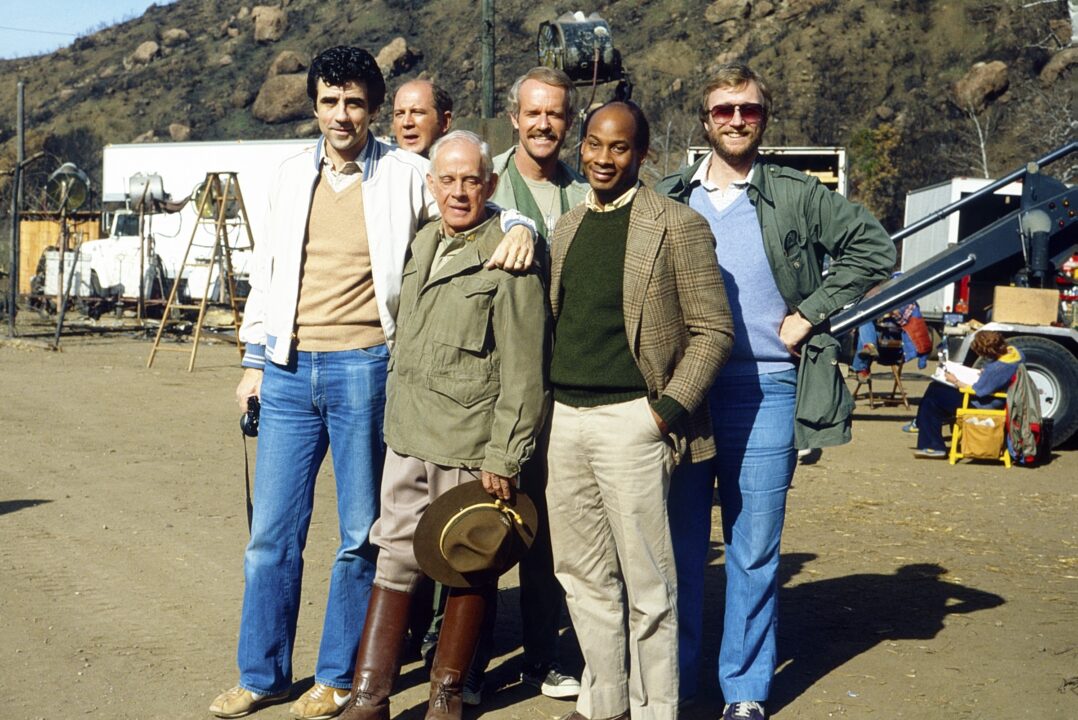 MASH, (aka M*A*S*H*), from left: writer and producer Dennis Koenig, David Ogden Stiers, Harry Morgan, Mike Farrell, writer and producers Thad Mumford, Dan Wilcox, on set, (19721983). TM &