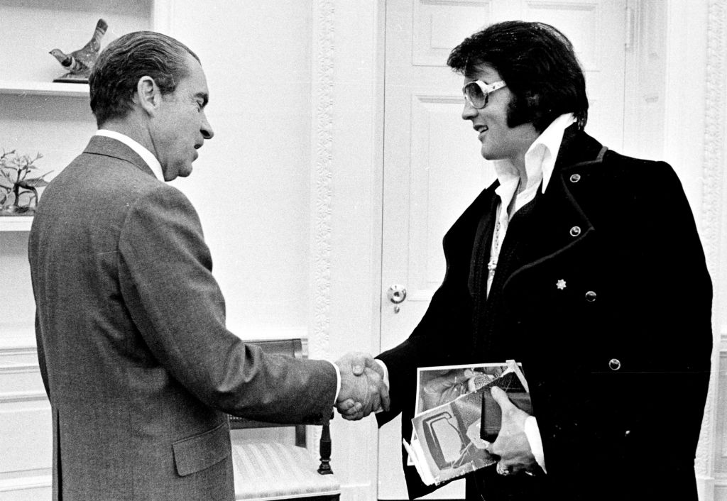 American politician US President Richard Nixon (1913 – 1994) and Rock and Roll musician Elvis Presley (1935 - 1977) shake hands during a meeting at the White House, Washington DC, December 21, 1970