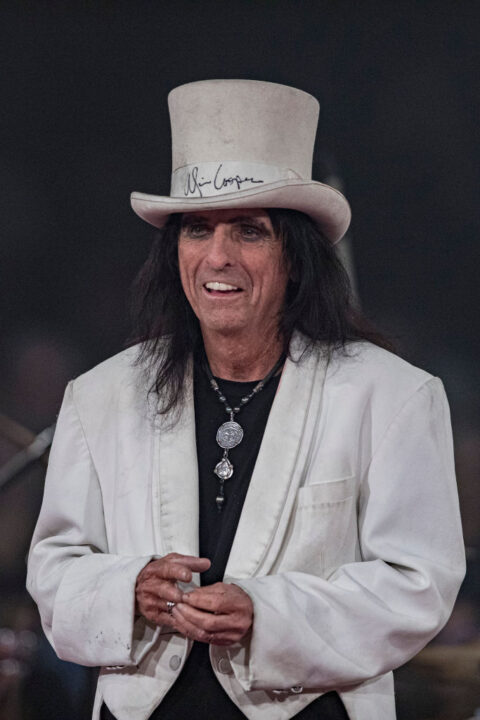Alice Cooper models his signature white tuxedo and autographed hat to be auctioned for charity at Alice Cooper's 21st Annual Christmas Pudding at Celebrity Theatre on December 09, 2023 in Phoenix, Arizona