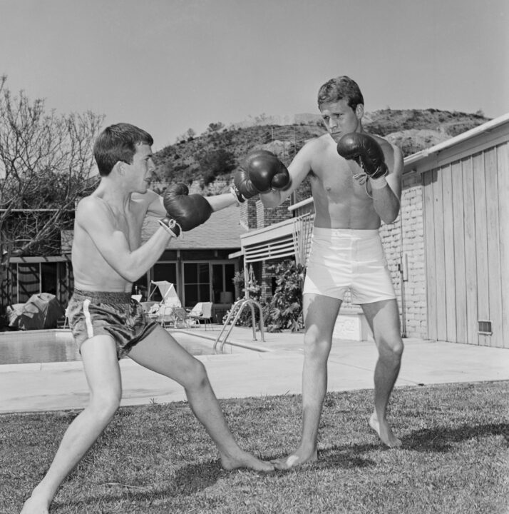 Unspecified - 1964: (L-R) Kevin O'Neal, Ryan O'Neal at home boxing, behind the scenes during the making of the ABC tv series 'Peyton Place'. 