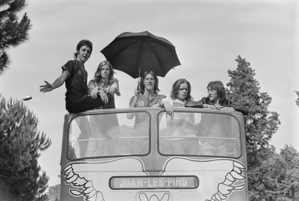 British singer and musician Paul McCartney, American photographer and musician Linda McCartney (1941-1998), American drummer Denny Seiwel, British musician Henry McCullough (1943-2016), and British singer and musician Denny Laine on the converted bus in which Wings are touring Europe, in Juan-les-Pins, France, 12th July 1972