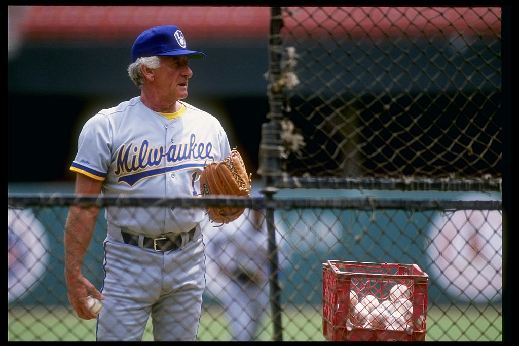 1990: Former catcher Bob Uecker of the Milwaukee Brewers stands beside basket of baseballs.