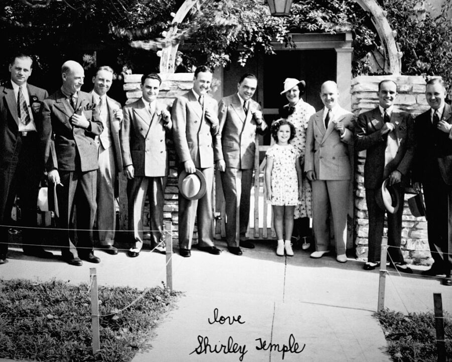 Shirley Temple pictured with J. Edgar Hoover and other FBI agents. Hoover was Director of the FBI from 1924 to 1972. Shirley Temple was a famous movie star as a child beginning in the mid 1930s. Ca. 1934-1940