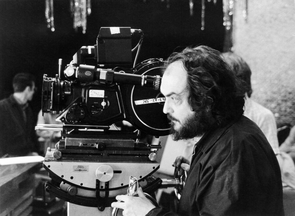 THE SHINING, director Stanley Kubrick setting up a shot, on set, 1980. 
