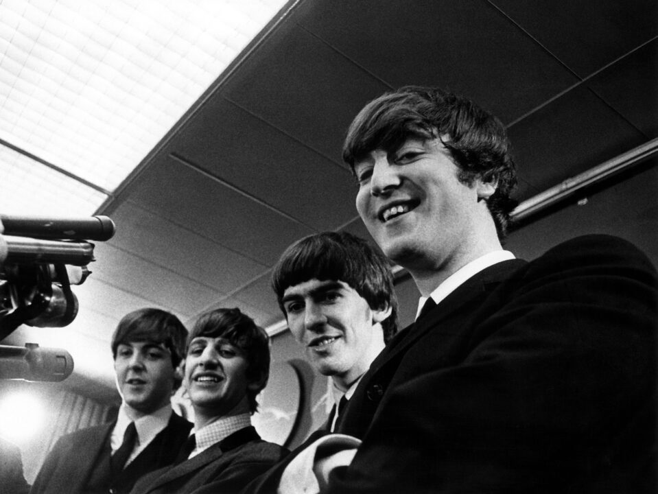BEATLES, THE: Paul McCartney, Ringo Starr, George Harrison, John Lennon, being interviewed at the airport, during their first US tour in 1964--part of TV documentary, 'The Entertainers' which aired, 11/13/64.