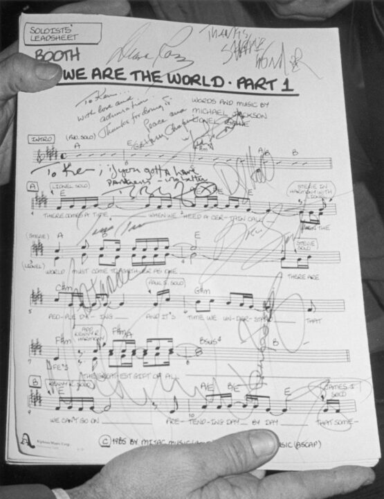 Viwe of the autographed first page of the sheet music for the song 'We Are the World,' written by Michael Jackson and Lionel Richie, 1985. The song was designed to raise awareness and funds for a worldwide hunger relief program, and its international success led the way for the Live Aid concerts later that year
