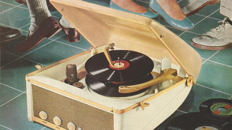 Vintage photograph of a portable record player on the floor in front of dancing feet in the 1950s.