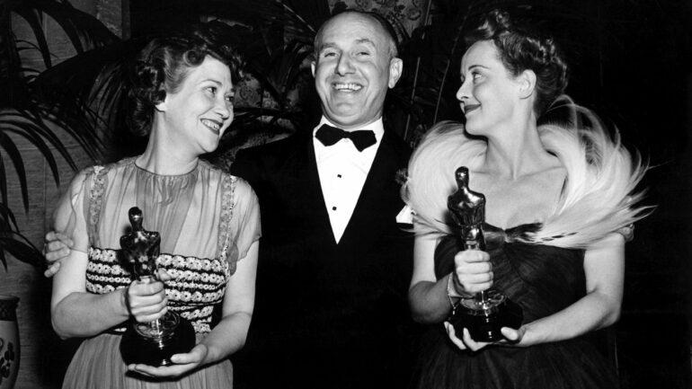 black and white image from the 11th Academy Awards in 1939. from left to right in the horizontal photo are Fay Bainter, Best Supporting Actress winner for 
