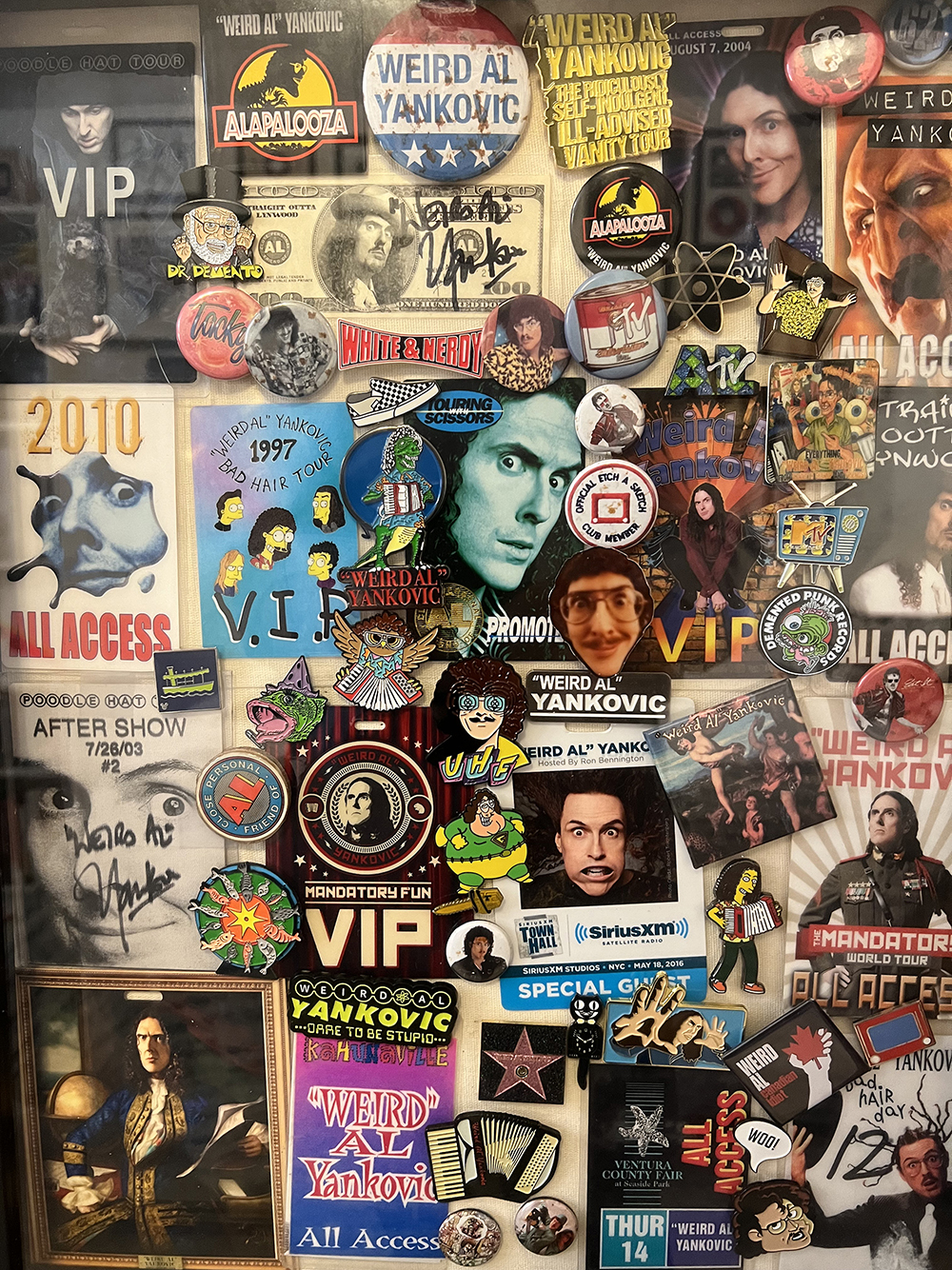 image from a Season 5 episode of MeTV's "Collector's Call." It is a vertical image filled with all sorts of "Weird Al" Yankovic memorabilia in the form of magnets and stickers on a refrigerator door.