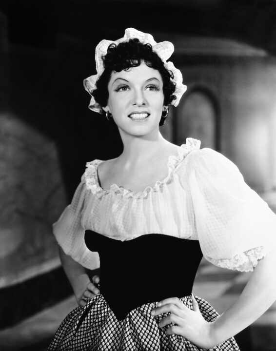 black and white image from the 1936 film "Anthony Adverse," depicting costar Gale Sondergaard in character wearing late-18th/early-19th century dress.