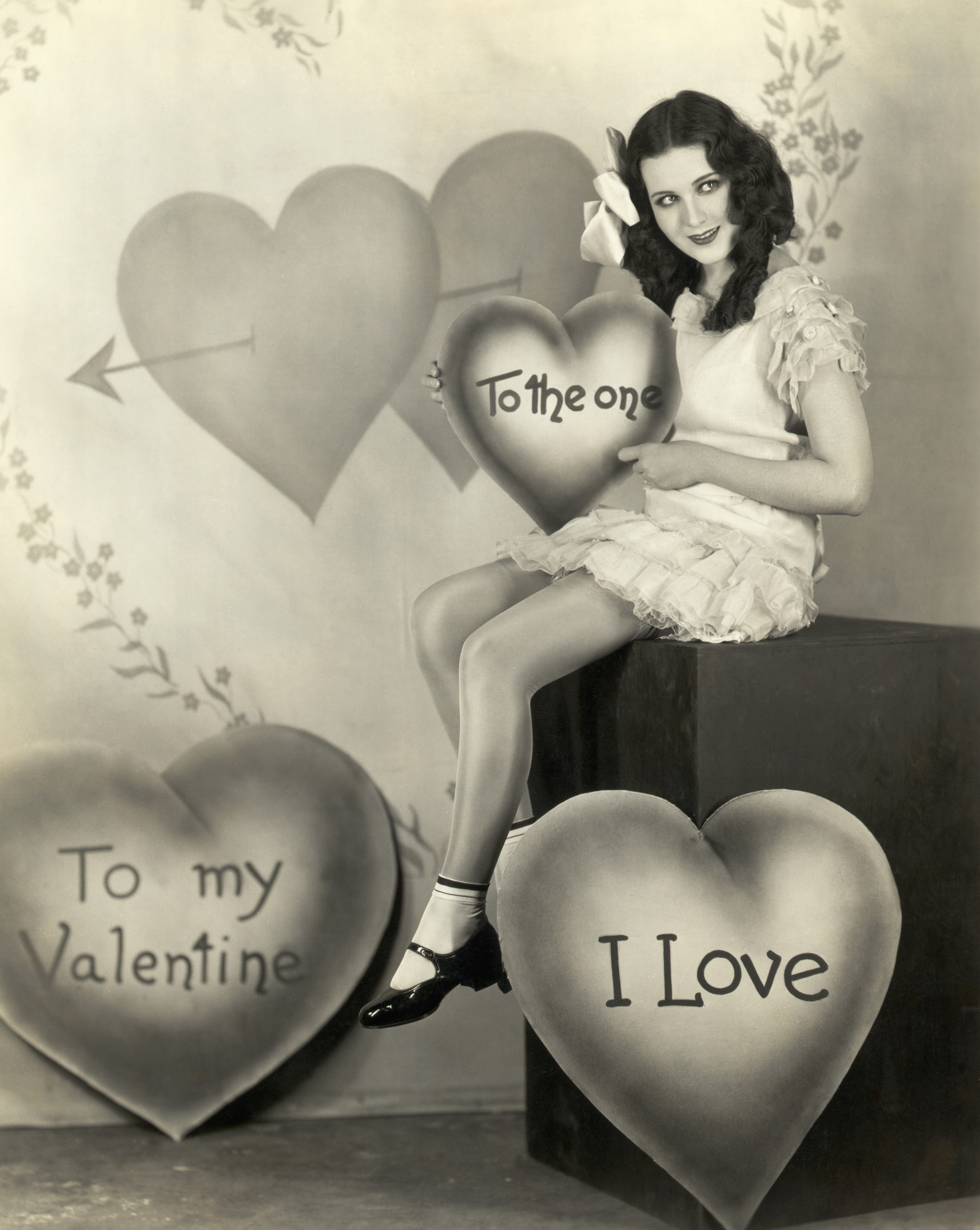 American film actress Mary Brian posing with St. Valentine's Day hearts and greetings, circa 1925.