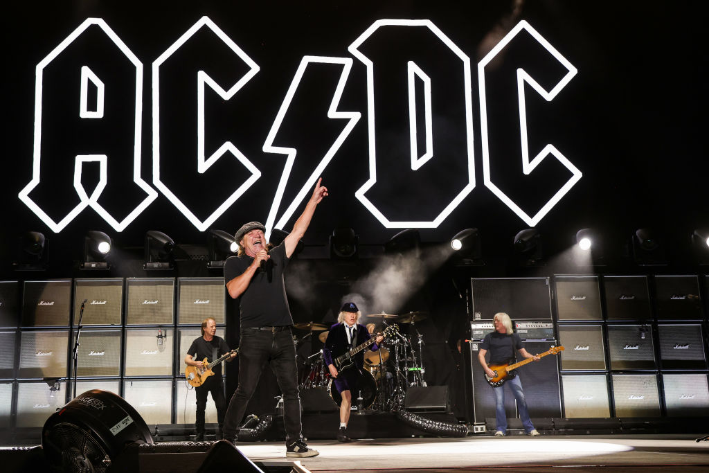 Stevie Young, Brian Johnson, Angus Young, and Cliff Williams of AC/DC perform onstage during the Power Trip music festival at Empire Polo Club on October 07, 2023 in Indio, California
