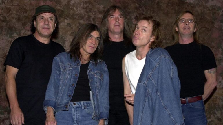 Members of the Australian rock band AC-DC pose for a photograph after the Rock Walk handprint ceremony September 15, 2000 at the Guitar Center in Hollywood, Ca. From left: Brian Johnson, Malcolm Young, Cliff Williams, Angus Young and Phil Rudd.