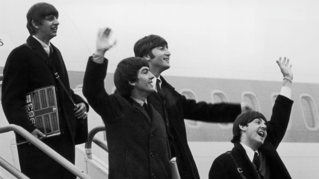 The Beatles (left to right: Ringo Starr, George Harrison (1943 - 2001), John Lennon (1940 - 1980), and Paul McCartney) step off the aeroplane which brought them back from their tour of the United States