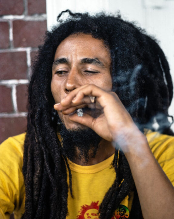 Bob Marley relaxes with friends in front of his house at 56 Hope Road on July 9, 1979 in Kingston, Jamaica