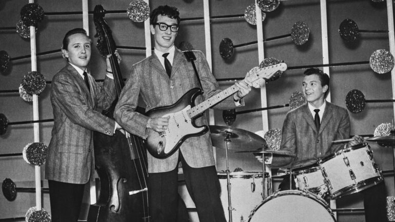 Buddy Holly and the Crickets during an appearance on the BBC TV show 'Off The Record', March 25th 1958. Left to right: Bassist Joe B Mauldin (1940 - 2015), guitarist and singer Buddy Holly (1936 - 1959) and drummer Jerry Allison (1939 - 2022).