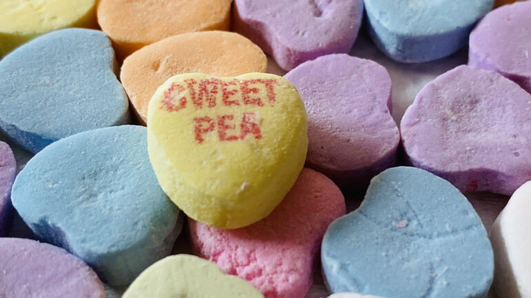 A macro shot of candy hearts