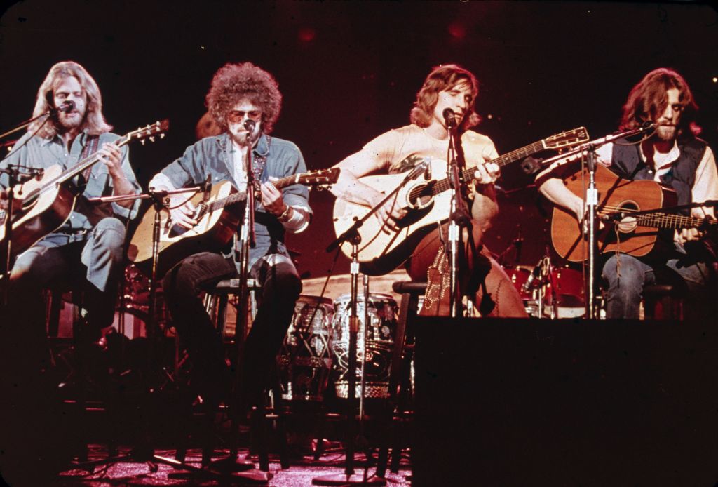 Members of the American soft-rock ensemble The Eagles sit on chairs as the perform on the television show 'Don Kirschner's Rock Concert,' 1979. Bandmembers are (left to right) Glenn Frey, Don Henley, Joe Walsh, and Don Felder