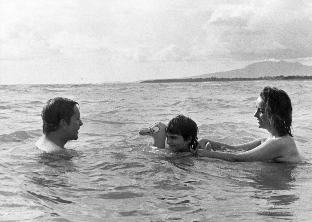 6th October 1963: Richard Burton (1925-1984) goes swimming in the sea with Elizabeth Taylor and her daughter Liza Todd, during filming of 'Night of the Iguana' in Mexico. 