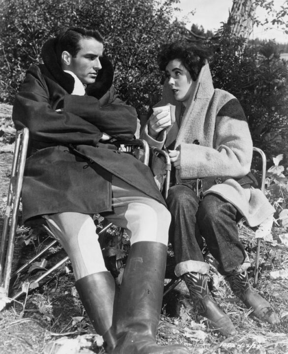 1951: Montgomery Clift (1920-1966) and Elizabeth Taylor share a relaxed moment on the set of the melodrama 'A Place In The Sun', directed by George Stevens for Paramount Pictures. 