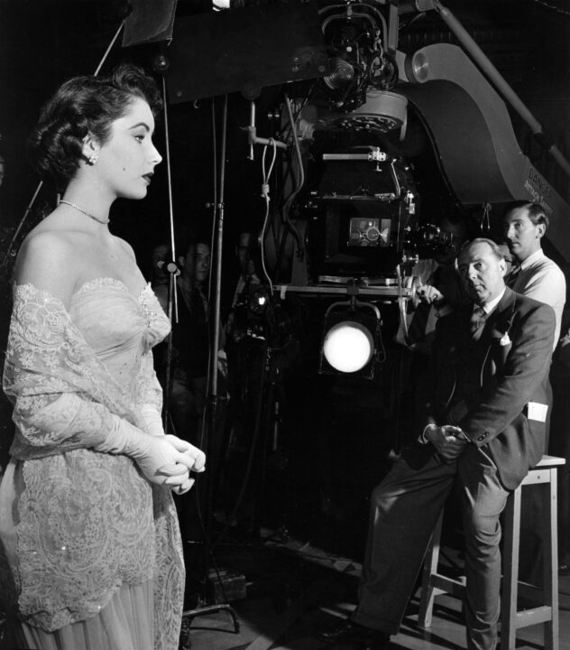 Elizabeth Taylor on the set of the film 'Conspirator' with Victor Saville (1895 - 1979) directing. 