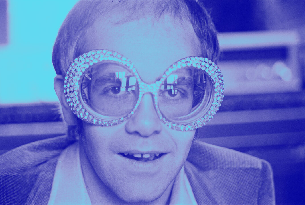 British singer-songwriter Elton John wearing a pair of his flamboyant trademark spectacles, 12th September 1974. 