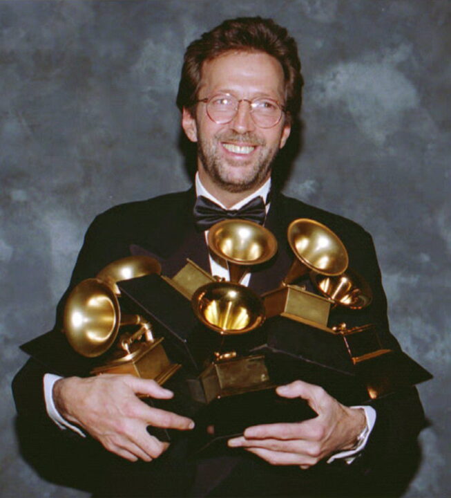 British rock star Eric Clapton poses with the six Grammys he won 24 February 1993 at the 35th annual Grammy Awards. His song "Tears in Heaven" won both as record and song of the year, and his album "Unplugged" won as album of the year