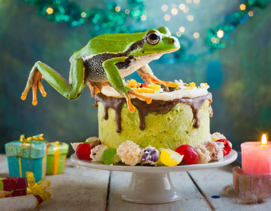 AI generated frog leaping over a birthday cake