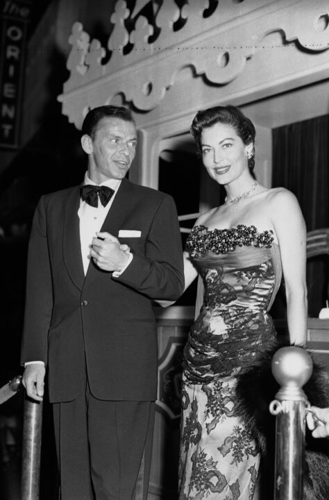 (Original Caption) 07/18/1951-Hollywood, CA: Frank Sinatra escorts Ava Gardner to MGM's Technicolor "Show Boat" premiere here, in the couple's first such appearance together. Shown on a replica of the show boat outside the Egyptian Theater, the pair holds hands for photographers. It is reported that Sinatra's wife will give him a divorce.