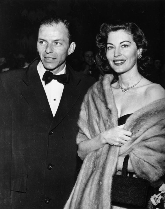 February 1952: American singer and actor Frank Sinatra (1915 - 1998) and the actress Ava Gardner (1922 - 1990) attending a Hollywood party. The two were married in 1948 and later divorced in 1957. 