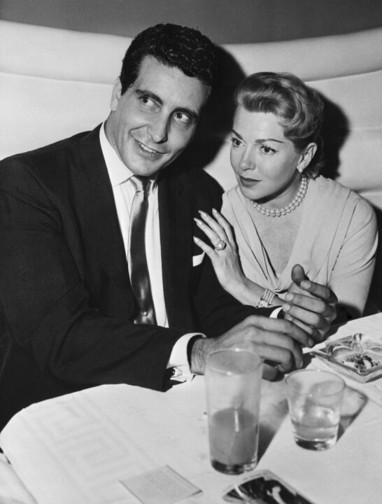 Underworld character Johnny Stompanato is pictured here with screen star Lana Turner at a Hollywood nightclub recently. Friday night Stompanato was found stabbed to death in the star's palatial Beverly Hills home and her daughter, Cheryl Crane, 14, is being held by juvenile authorities in connection with the stabbing.