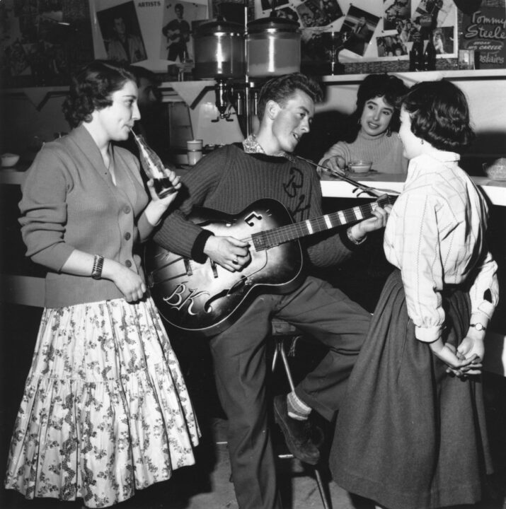 February 1958: Singer and guitarist Bill Kent entertains some teenage fans in 'The Two I's Coffee Bar' in Soho. 