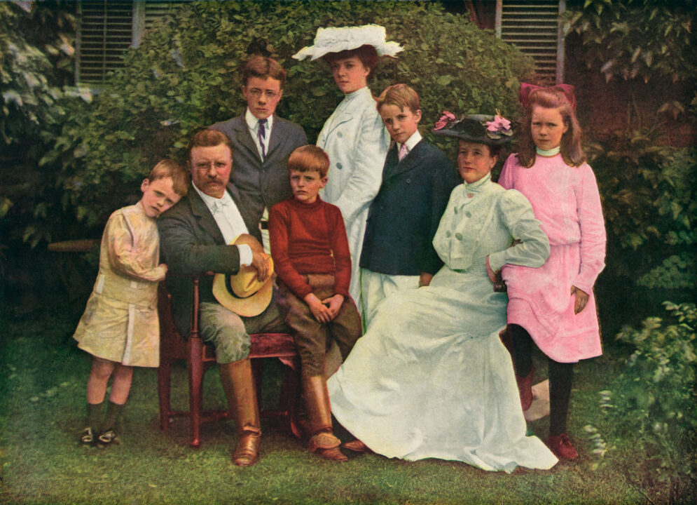 Colorized portrait of American President Theodore Roosevelt (1858 - 1919) (second left) and his family as they pose outside, Oyster Bay, New York, 1903. Pictured are, from left, son Quentin Roosevelt (1897 - 1918), Roosevelt, sons Theodore Roosevelt Jr (1887 - 1944) and Archibald Roosevelt (1894 - 1979), daughter Alice Roosevelt (later Longworth, 1884 - 1980), son Kermit Roosevelt (1889 - 1943), wife and First Lady Edith Roosevelt (nee Carow, 1861 - 1948), and daughter Ethel Roosevelt (later Derby, 1891 - 1977)