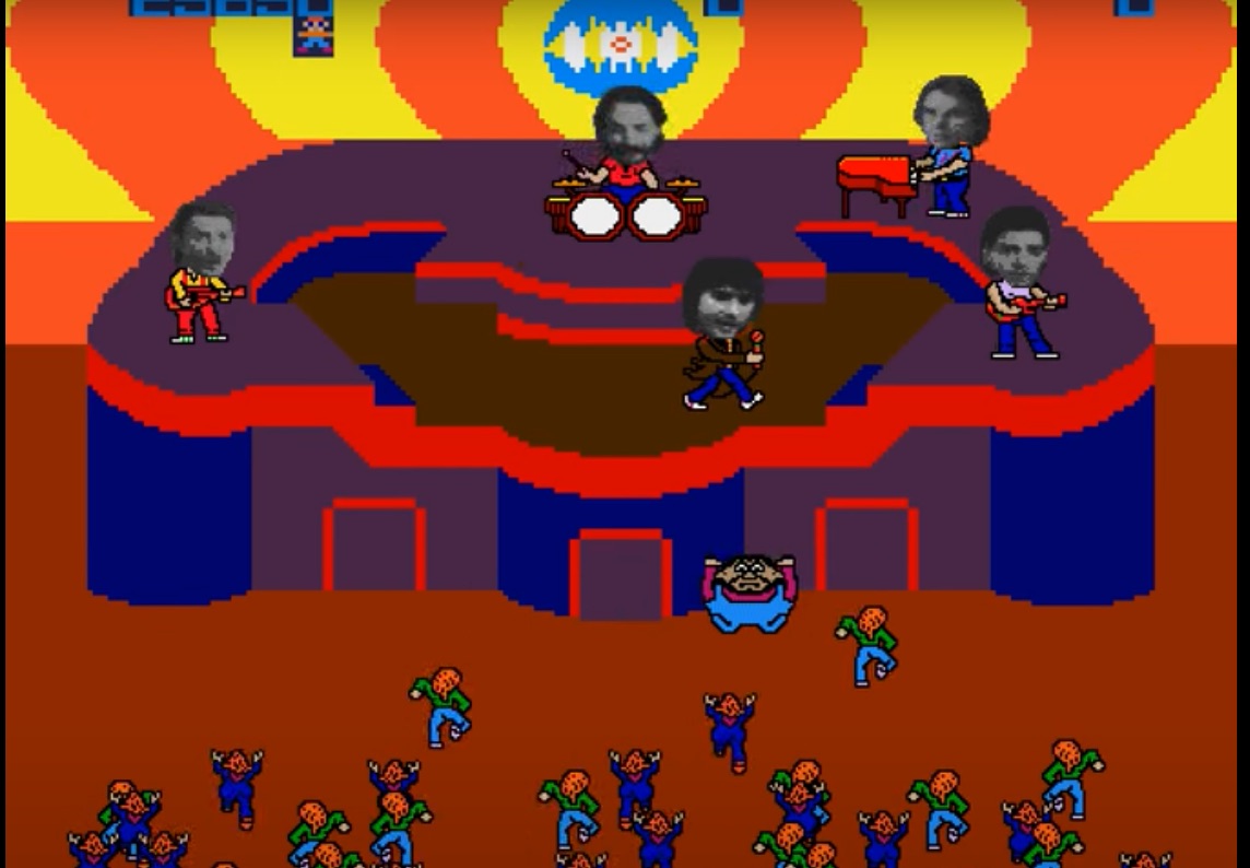 screenshot from the 1983 Bally Midway arcade video game Journey. It shows computerized versions of the band members, with black-and-white digitized photographs of their actually faces added to the computer bodies. They are performing onstage in front of a wild audience.