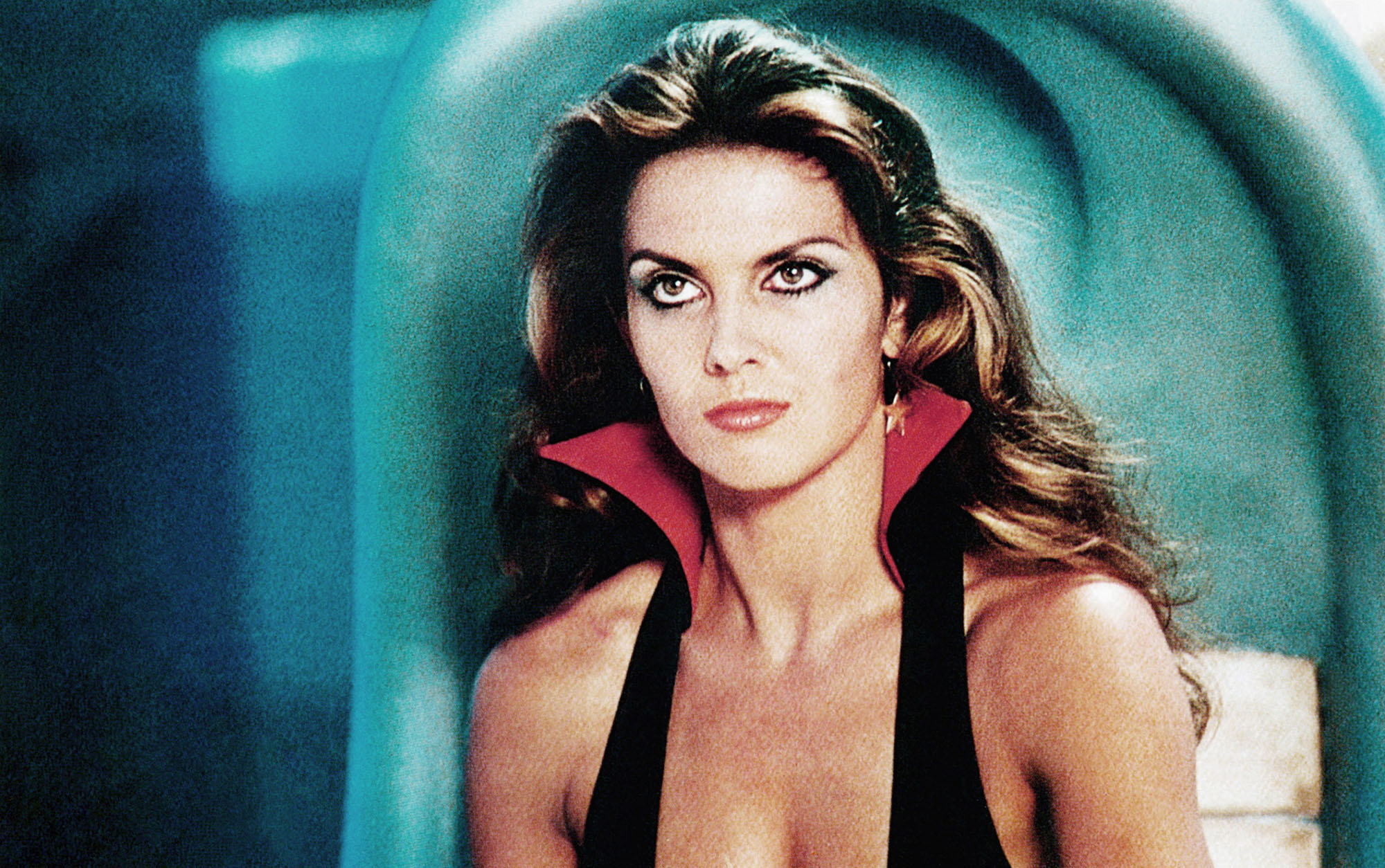 image from the 1979 space opera movie "Starcrash." It is a medium headshot of Caroline Munro as Stella Star, a space smuggler. She is wearing a low-cut shirt with a pointed collar.