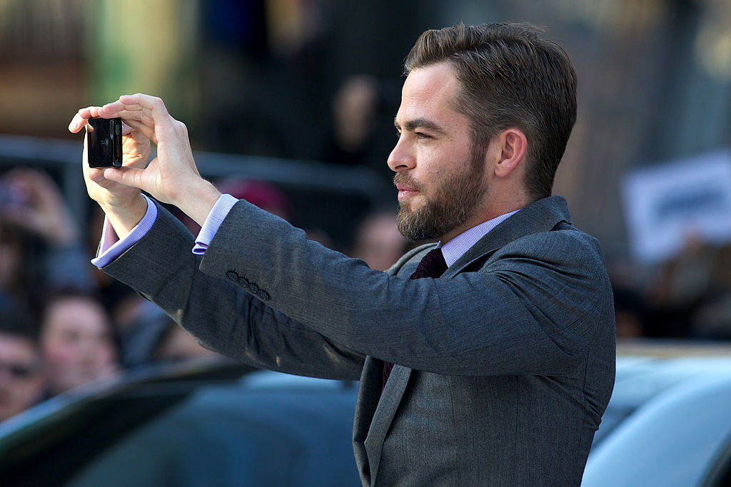 US actor Chris Pine takes a picture with a mobile phone as he arrives for the international premier of his latest film "Star Trek Into Darkness" in London's Leicester Square on May 2, 2013